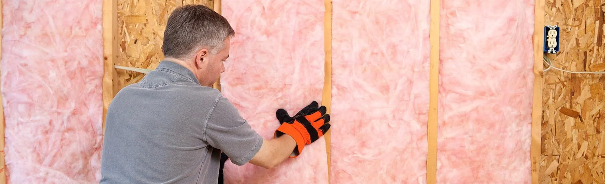 Builder adding insulation to home walls